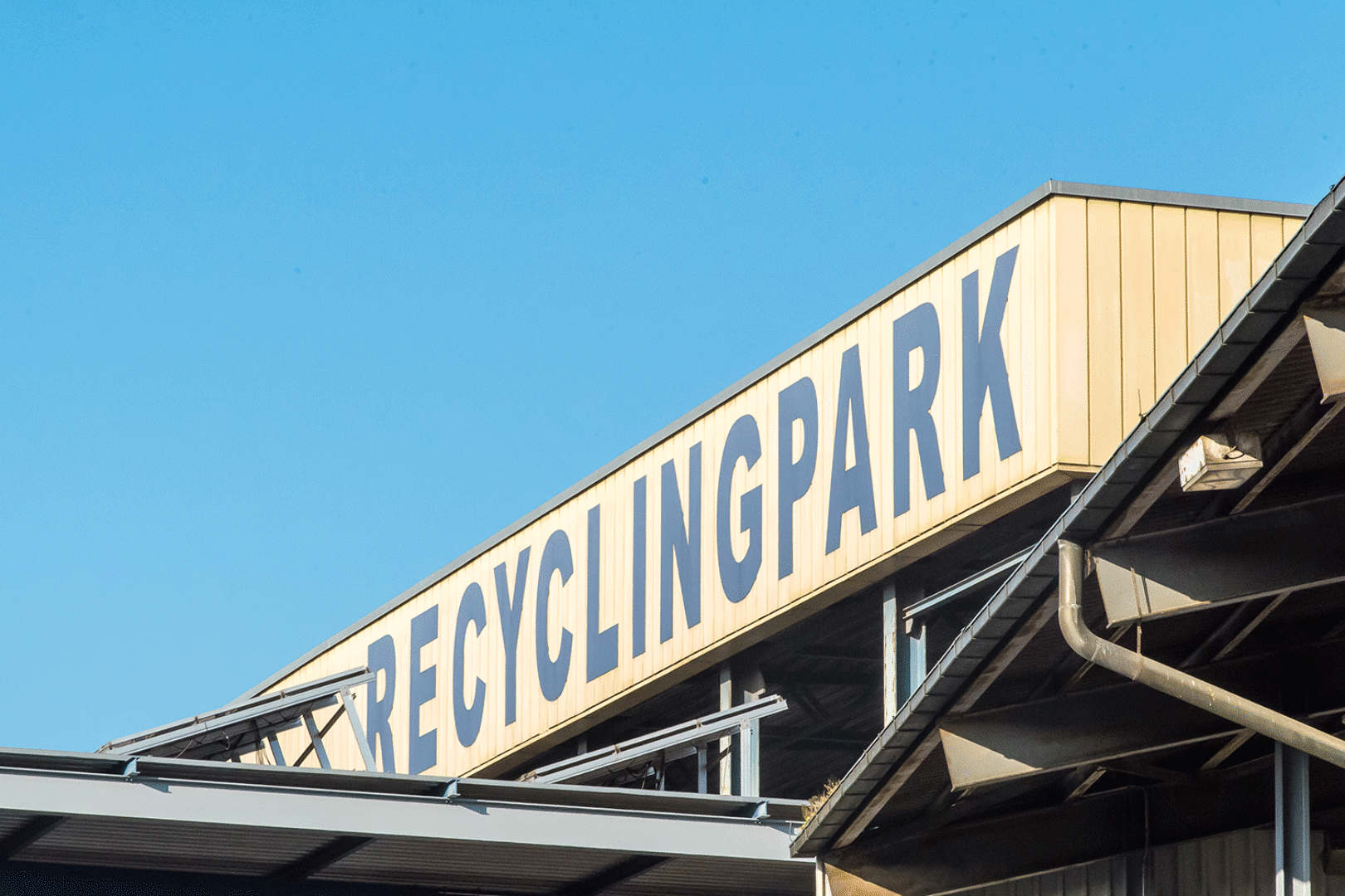 A building with "RECYCLING PARK" written on its side.