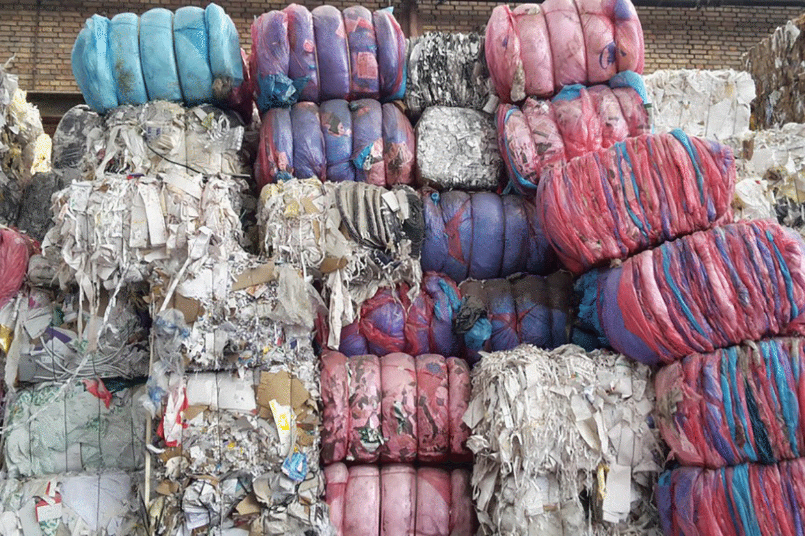 Bundles of shredded paper and cardboard in various colors.